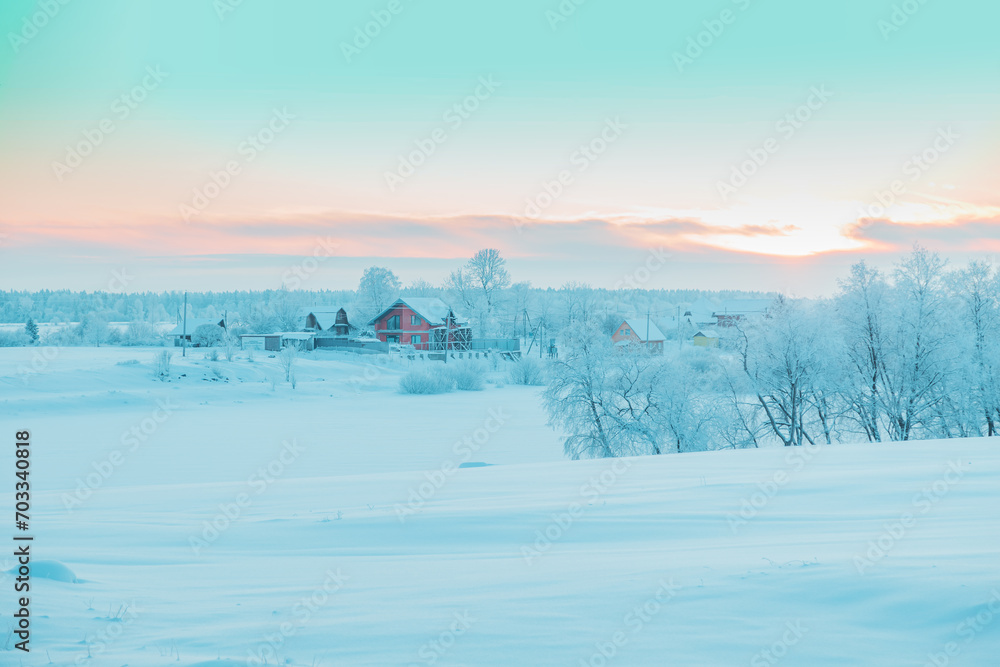 Fototapeta premium Beautiful winter landscape with snow-covered trees and houses.