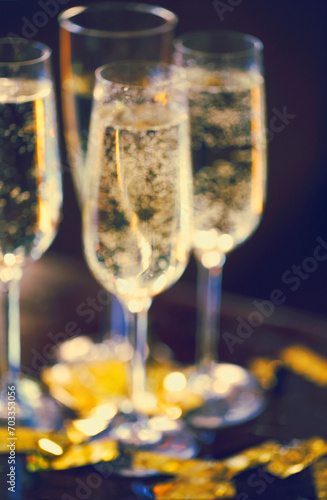 Champagne Flutes In Golden Sparkle Background with golden confetti