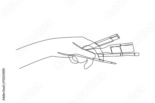 Continuous one line drawing people holding drawing tools. Stationery Concept. Single line draw design vector graphic illustration. © Vectorillustrator