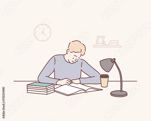 Smiling young man sitting at desk working on laptop writing letter in paper notebook. Hand drawn style vector design illustrations.