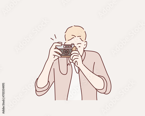  man taking photos with vintage camera outdoor. Hand drawn style vector design illustrations.