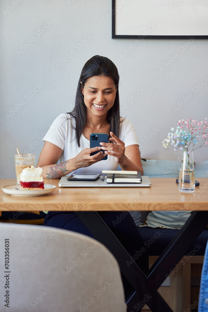 Smiling woman at cafe using smartphone Smiling woman at cafe using smartphone