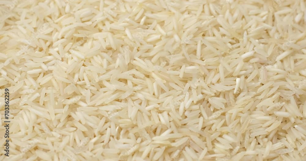 Raw rice basmati falling down on heap and rotation. Asian Chinese Thai Japanese Indian traditional food Raw rice basmati falling down on heap and rotation. Asian Chinese Thai Japanese Indian traditional food