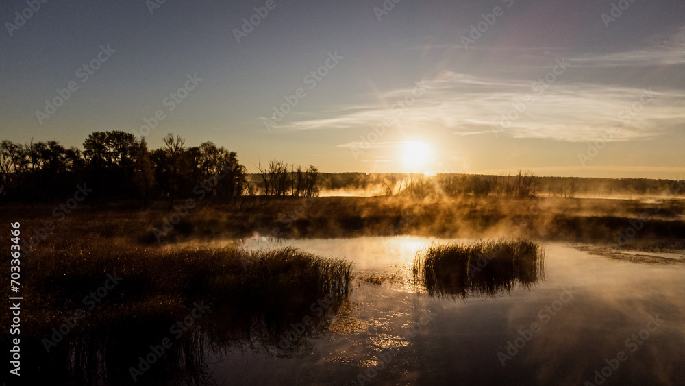 Colorful fog over the lake in autumn at dawn