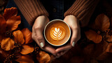 still life with coffee cup, Top view of woman hands holding coffee with latte art on seasonal autumn spring leaves background, banner, poster, invitation
