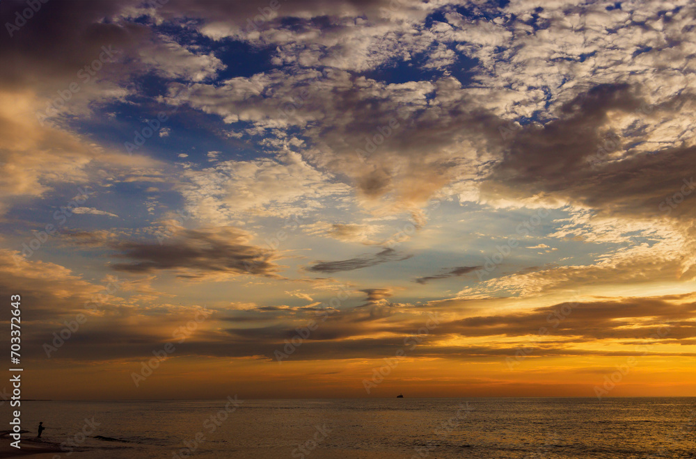 Sunset is accompanied by beautiful, colorful, bright sky at horizon