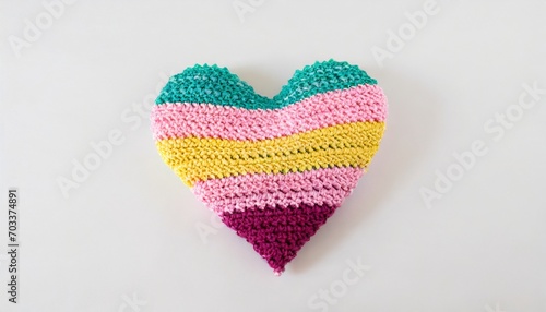 crocheted multi colored heart on a white background © Debbie