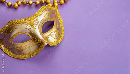 traditional golden venetian mask for festival mardi gras on purple background