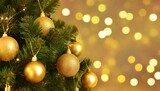 christmas tree with gold baubles close up against backdrop of golden sparkling christmas lights wide format banner background with atmosphere of celebration and magic
