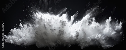 Explosion of white colored powder on black background