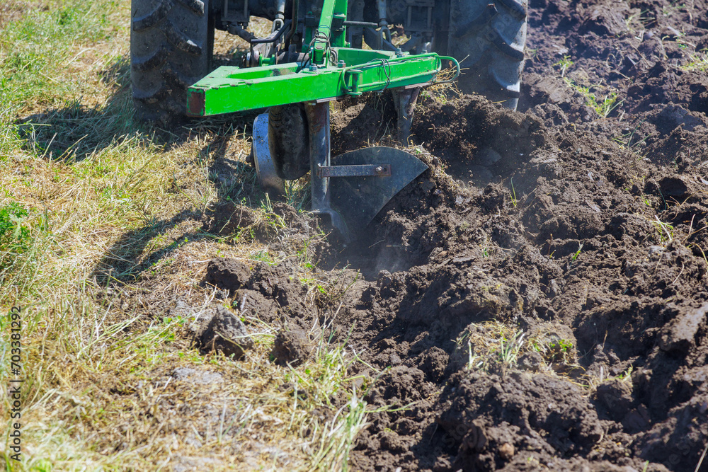 Preparation of land for sowing in spring season by farmer in tractor Preparation of land for sowing in spring season by farmer in tractor