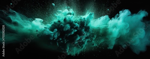 Explosion of teal green colored powder on black background
