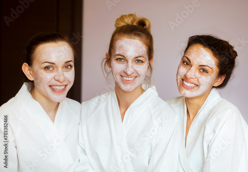 Three young happy women at spa resort #703382466