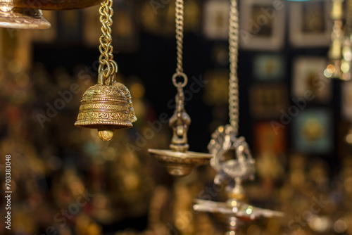 Beautiful brass hand bell for Puja, works of handicraft, for sale during International Trade Fair in Kolkata. Selective focus.