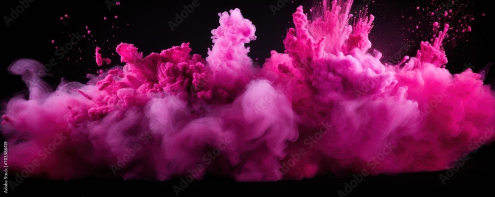 Explosion of magenta pink colored powder on black background