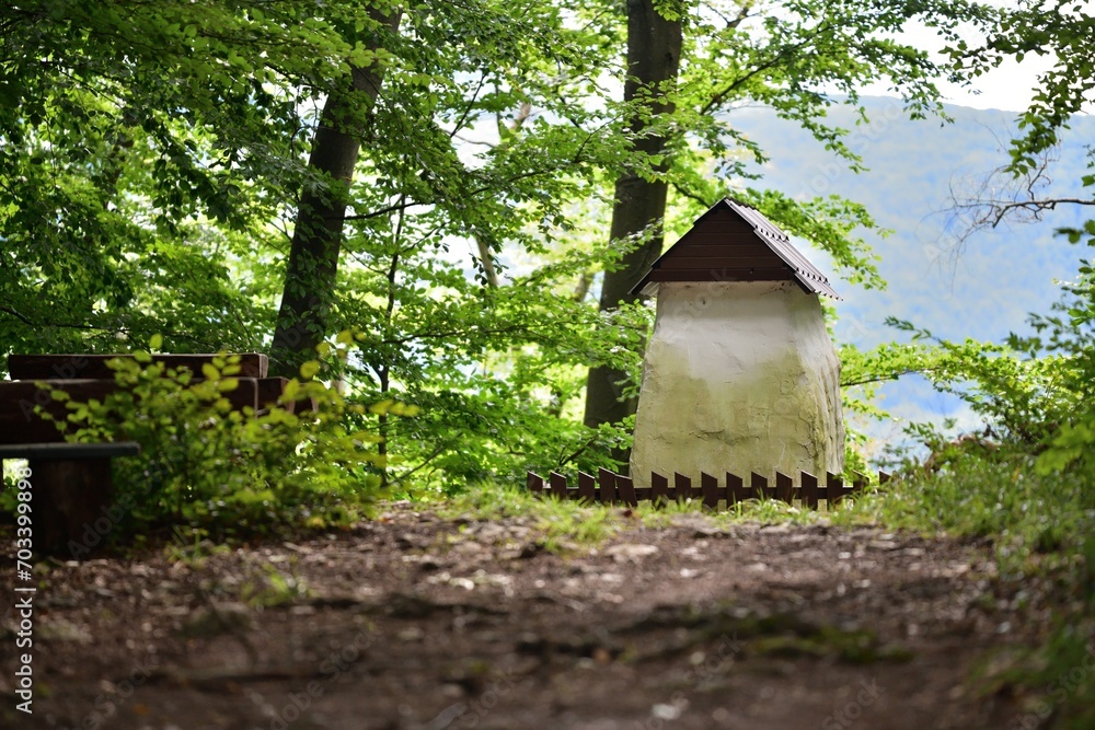 Historic concrete hut with a wooden roof for tourist decoration in the forest