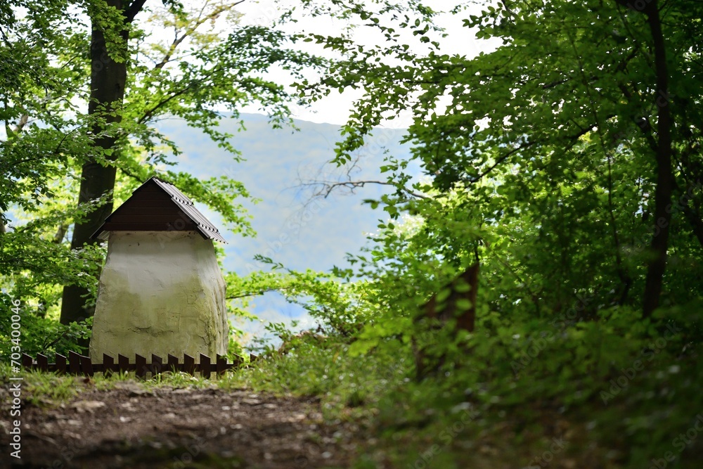 Historic concrete hut with a wooden roof for tourist decoration in the forest