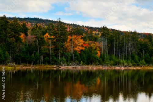 Fall scene Shavers Lake in the Fall with blue sky and puffy white clouds