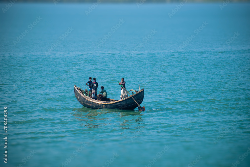 Traditional Fishing Boat Bobs on Serene Waters off Bangladesh Coast in St. Martin Island, Bangladesh Traditional Fishing Boat Bobs on Serene Waters off Bangladesh Coast in St. Martin Island, Bangladesh
