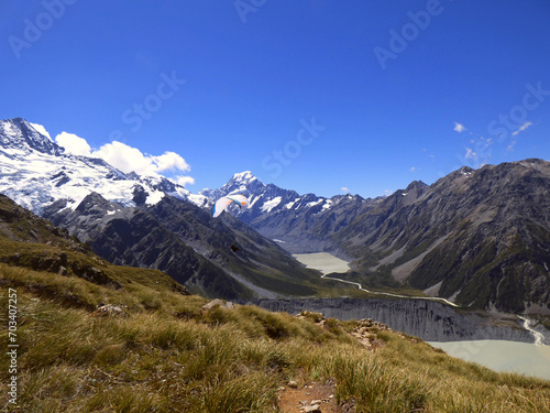 Mueller hut track, Aoraki National park, New Zealand. Southern Alps and Mt. Cook in the background, glacial lake in the front. Sunny day in the summer with clear skies and beautiful view. photo