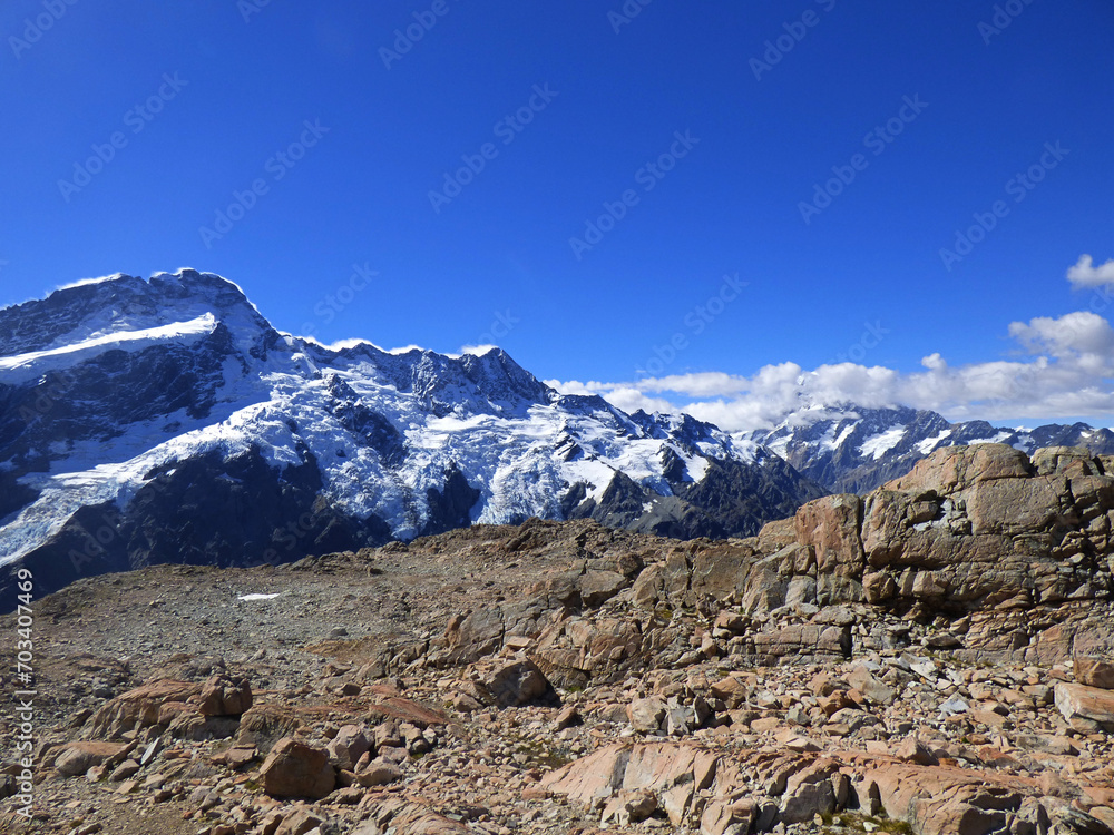 Landscape photograph of Mueller hut track, Aoraki National park, New Zealand. Southern Alps and Mt. Cook in the background. Sunny day in the summer with clear skies and beautiful view.