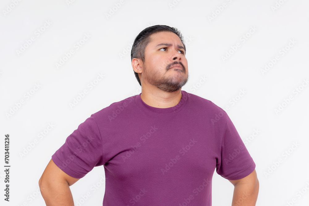 Obraz premium A middle aged man looking dumbfounded, looking to the right. Wearing eyeglasses and a purple waffle shirt, Isolated on a white background.