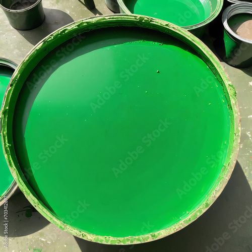 A large can of green oil colour on a concrete floor, renovation in an apartment. photo