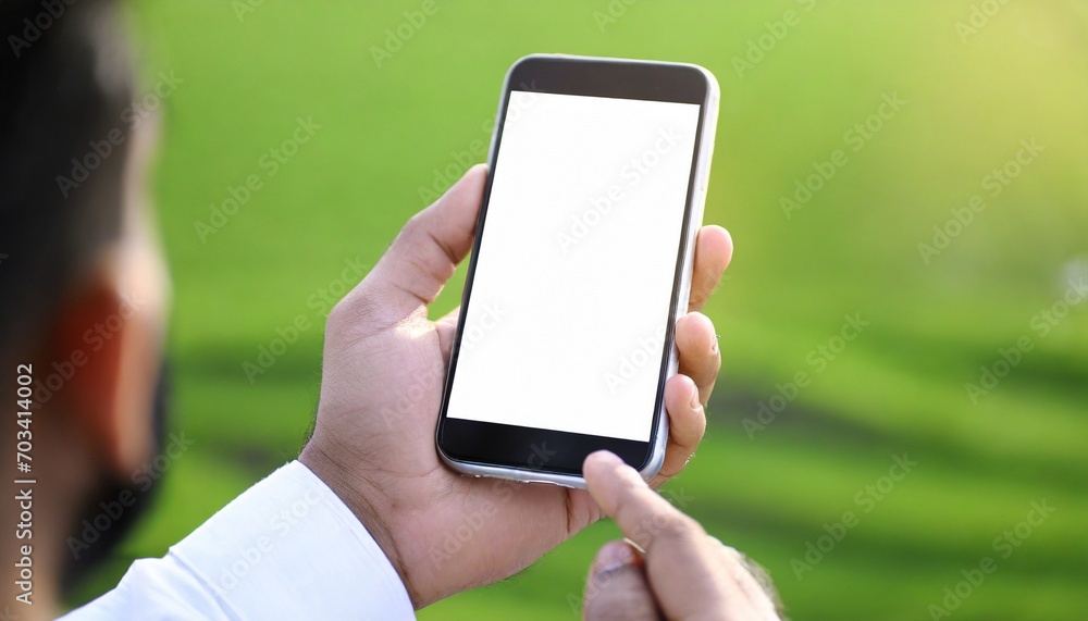 Close up of man hand holding modern smart phone mockup, green background