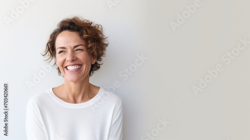 Mature Caucasian Woman Smiling Genuinely  White Casual Wear  Simplistic Elegance