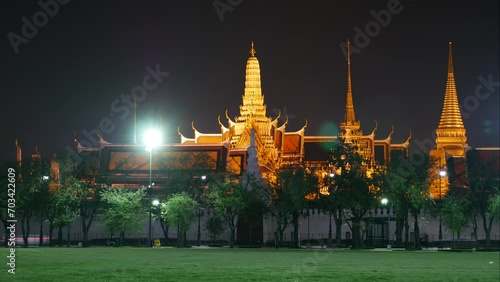 Time lapse of traffic in front of Wat Phra Kaew (Temple of Emerald Buddha), Bangkok, Thailand. It is one of the most popular tourist destinations in Bangkok.  photo
