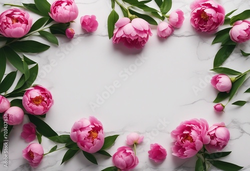 Beautiful pink peony flowers on white stone table with copy space for your text top view and flat lay