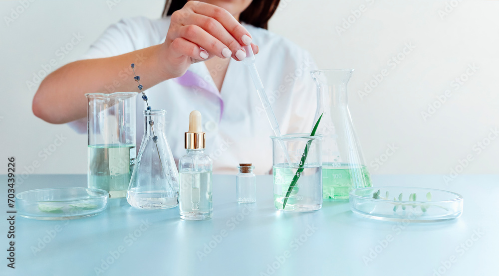 Woman examining green plant in laboratory