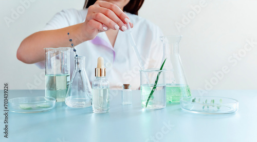 Woman examining green plant in laboratory