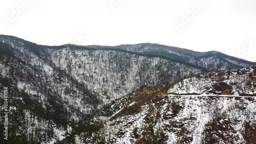 Beautiful nature footage of a mountains covered in snow and evergreen trees