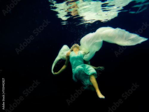Lexia Smith underwater with long dress on