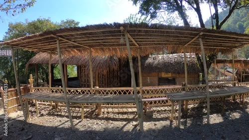 The traditional homes in Naga Heritage Village, Nagaland, captivate with their unique architecture and cultural significance. These rustic structures beautifully preserve and showcase Naga lifestyle. photo