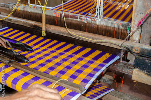 Fotografi Cotton weaving on a traditional wooden handloom