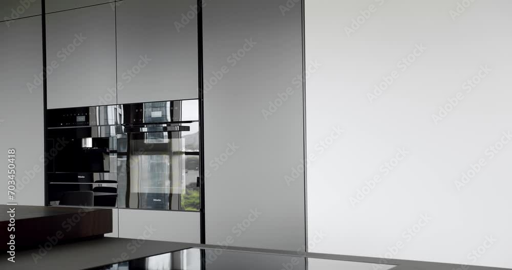Real Luxury kitchen with an island. Modern kitchen and bar brown chairs in kitchen room in minimalist apartment. Modern room with minimalist dining table. Domestic Kitchen with modern sink. Real Luxury kitchen with an island. Modern kitchen and bar brown chairs in kitchen room in minimalist apartment. Modern room with minimalist dining table. Domestic Kitchen with modern sink.