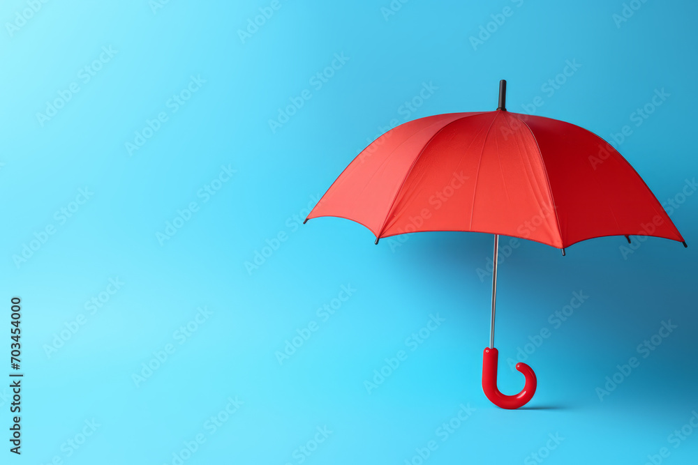 red toy umbrella isolated blue background insurance concept