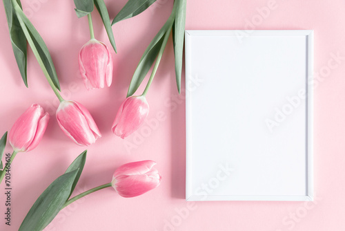 Fototapeta Naklejka Na Ścianę i Meble -  Flowers composition romantic. Flowers pink tulips, photo frame on pastel pink background. Wedding. Birthday. Happy woman's day. Mothers Day. Valentine's Day. Flat lay, top view, copy space
