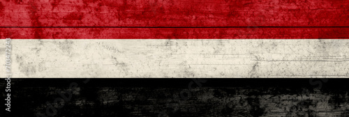 Yemen flag on a wooden surface. Yemen grunge flag. photo