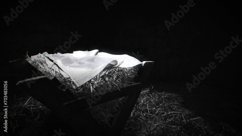 Black and white shot of the manger, dimly top lit, film grain. photo