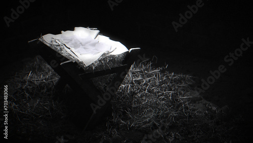 Black and white shot of the manger, dimly top lit, film grain.