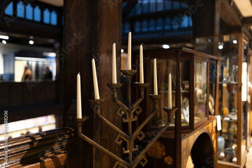 Wooden candlestick with seven candles in the shape of a slide. photo