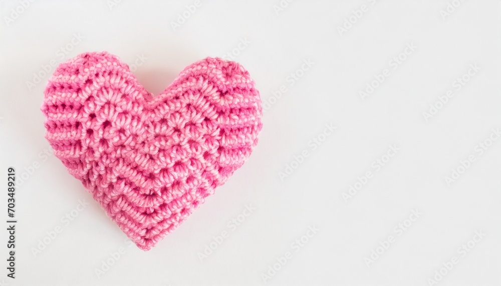 crocheted pink heart on a white background