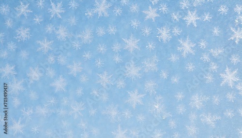 snowflakes frozen to the window on a winter day abstract blue background