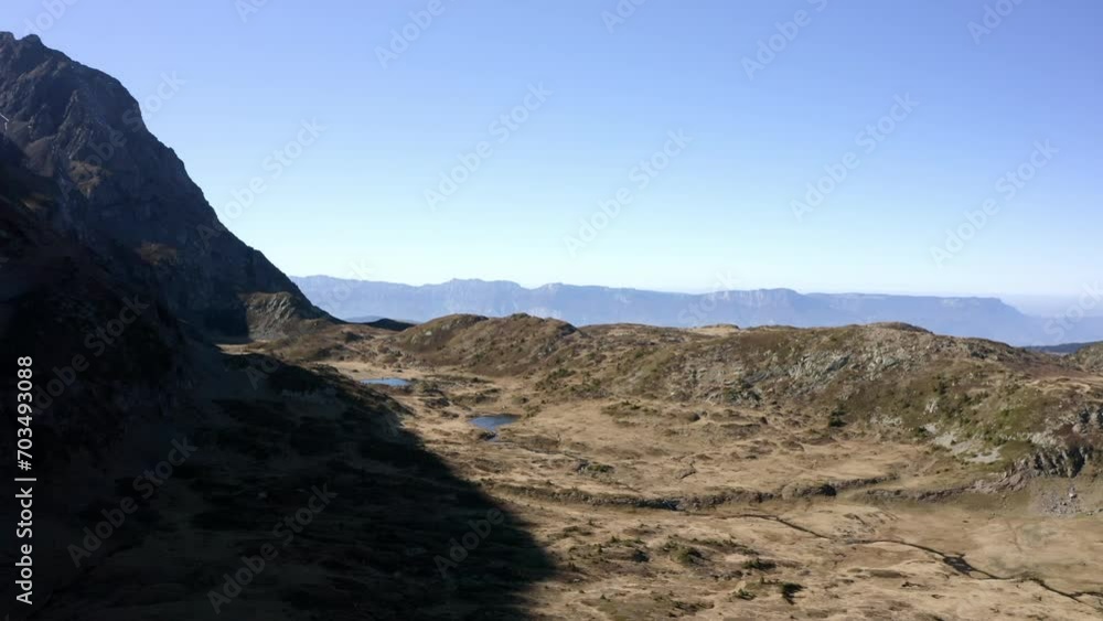 Aerial Panning Scenic View Of Natural Rock Formations Against Clear Sky On Sunny Day - French Alps, France Aerial Panning Scenic View Of Natural Rock Formations Against Clear Sky On Sunny Day - French Alps, France