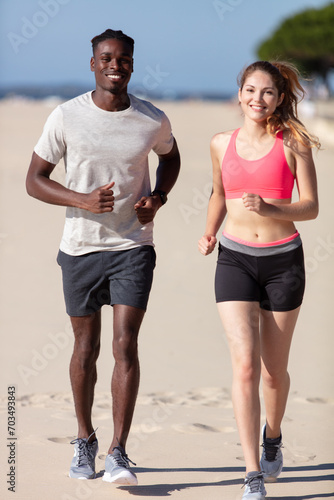 couple running in the beach