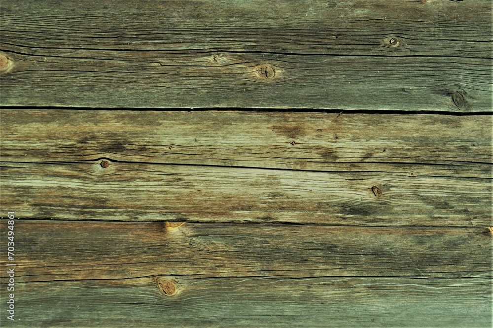 Obraz premium Fragment of an old natural wooden wall. The cracked wooden wall of an old building.