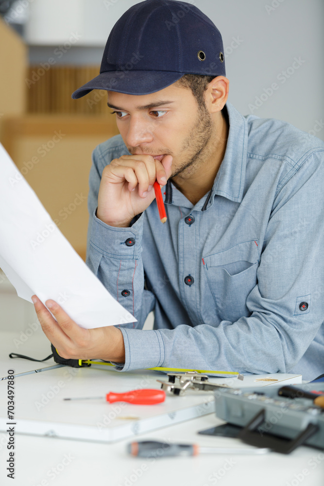 man with a pencil looking at drawing man with a pencil looking at drawing